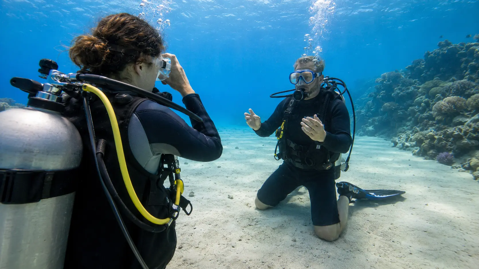 Instructor supervising mask skills during a scuba refresher course in Hurghada